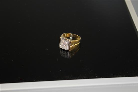 An 18k yellow metal and nine stone pave set diamond square signet ring, size W/X, gross 14.5 grams,